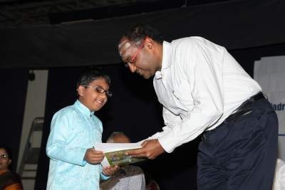 Junior child receiving prize from the chief Guest Mr. Vidya Shankar